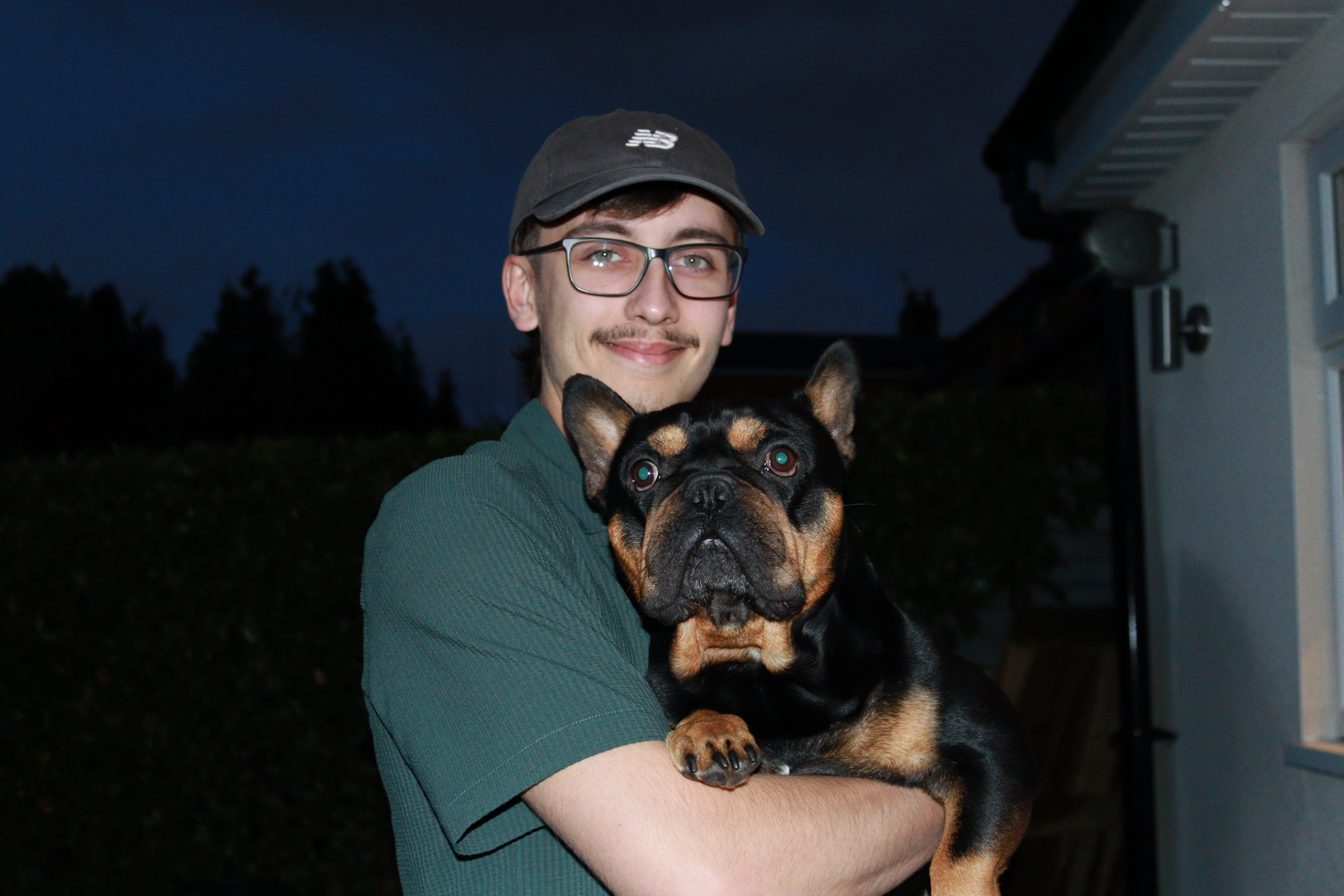 Jack, founder of Longmore Game Studios LTD, holding his dog